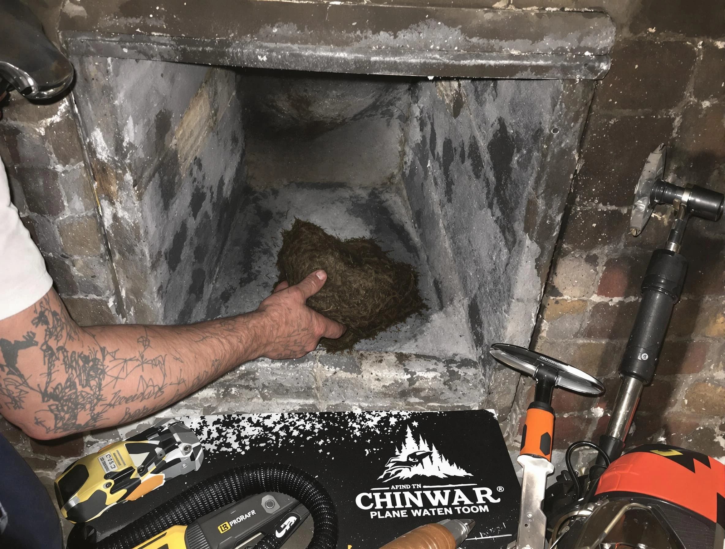 New Bedford Chimney Sweep safely removing debris and screening chimney in New Bedford, MA